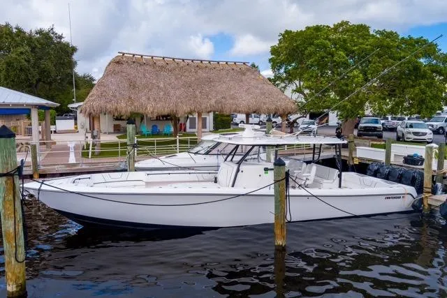 The Image of 2020 Contender 44 ST boat cruising on a calm, overcast waterway. - 0