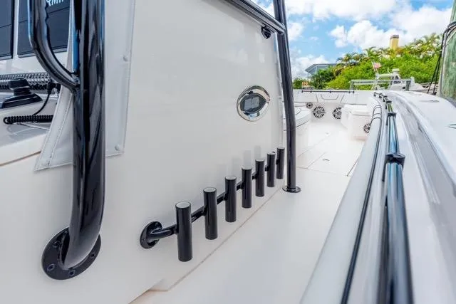 Slide: The Image of 2020 Contender 44 ST boat docked between two other vessels in a marina. - 25