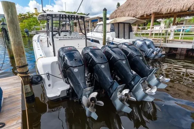 Slide: The Image of 2020 Contender 44 ST boat cockpit with illuminated navigation screens and red lighting. - 7