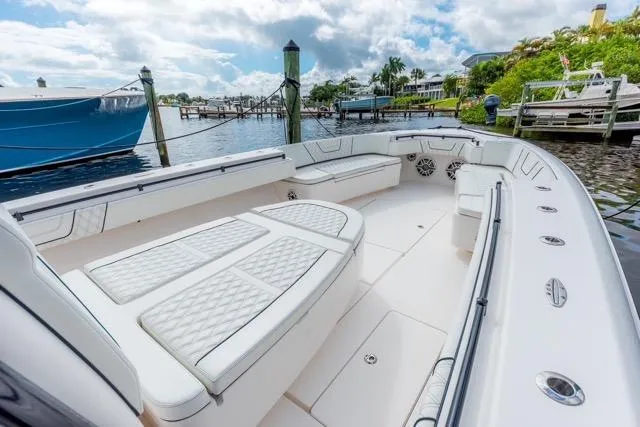 Slide: The Image of 2020 Contender 44 ST boat with four powerful outboard engines docked at marina. - 9