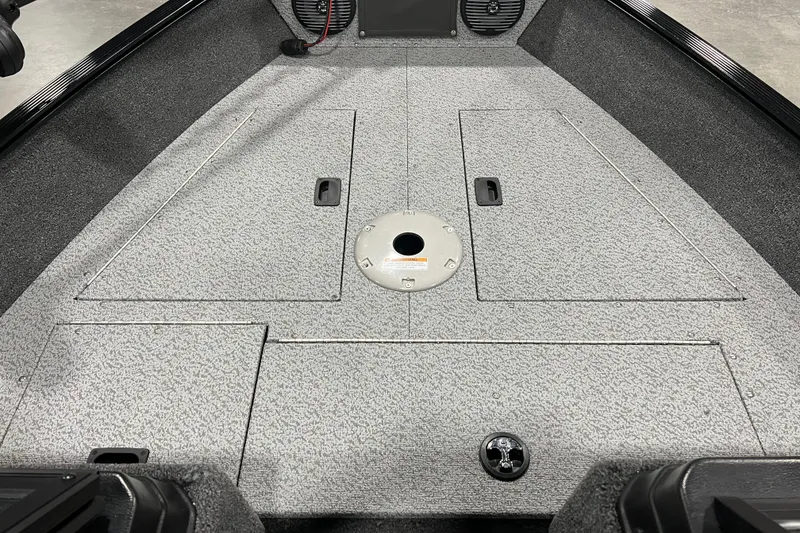 Slide: The Image of 2024 Lund 1650 Angler Sport boat interior with storage compartments and speaker. - 13