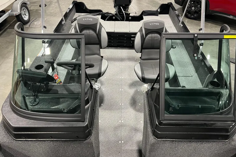 Slide: The Image of 2024 Lund 1650 Angler Sport boat interior with dual seats and windshield. - 16