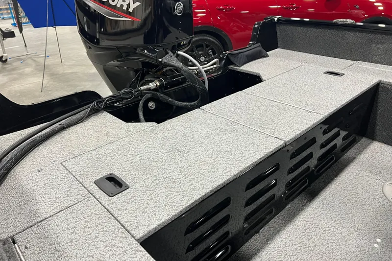 Slide: The Image of 2024 Lund 1650 Angler Sport boat interior with Mercury engine, showcasing storage compartments. - 3