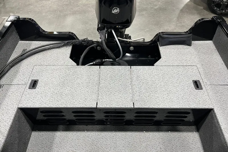 Slide: The Image of 2024 Lund 1650 Angler Sport boat interior with motor and storage compartments. - 4
