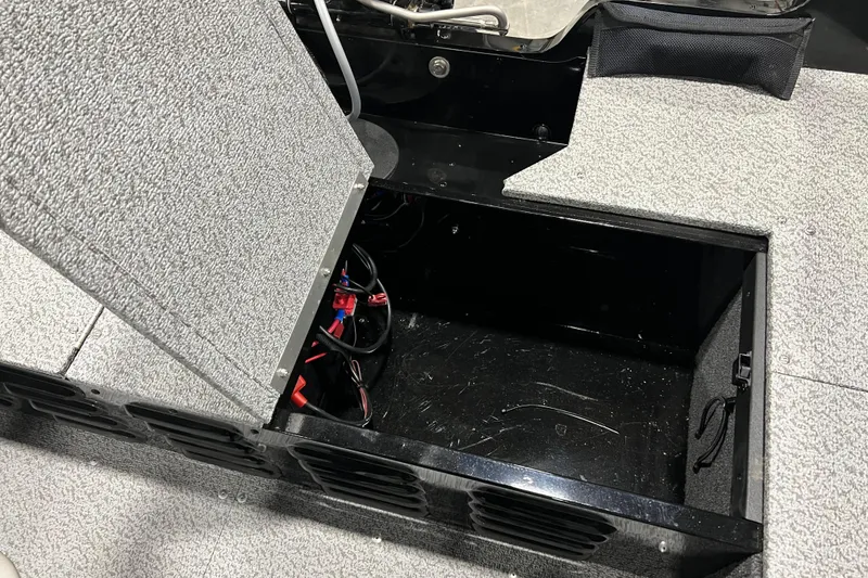 Slide: The Image of Open storage compartment in 2024 Lund 1650 Angler Sport boat, showing interior wiring. - 5