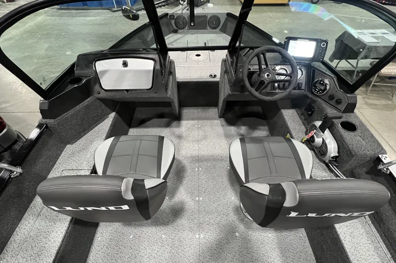 Slide: The Image of 2024 Lund 1650 Angler Sport boat interior with dual seats and modern dashboard. - 7