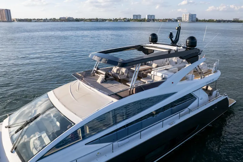 Slide: The Image of Luxurious 2020 Pearl 80 yacht cruising on calm waters under a clear sky. - 10