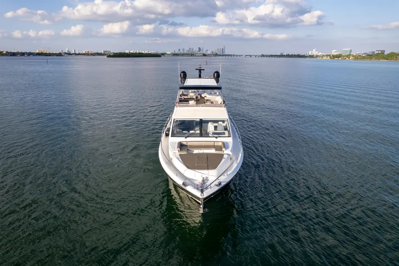 Slide: The Image of Luxurious 2020 Pearl 80 yacht cruising on calm waters under a partly cloudy sky. - 15