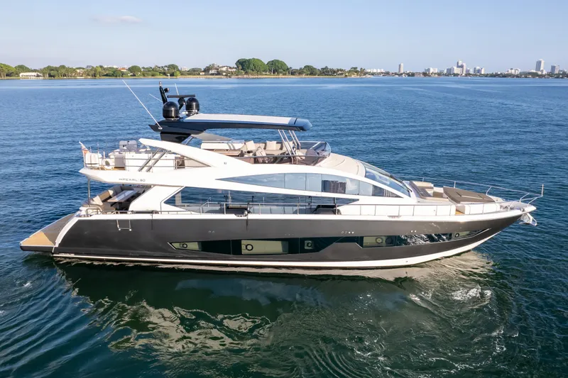 Slide: The Image of Luxurious 2020 Pearl 80 yacht cruising on serene blue waters. - 18