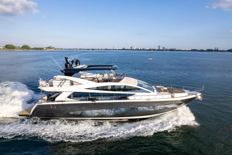 Slide: The Image of Luxurious 2020 Pearl 80 yacht cruising on open water under clear blue skies. - 19
