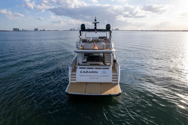 Slide: The Image of Luxury Pearl 80 yacht on open water, 2020 model, with city skyline in background. - 20