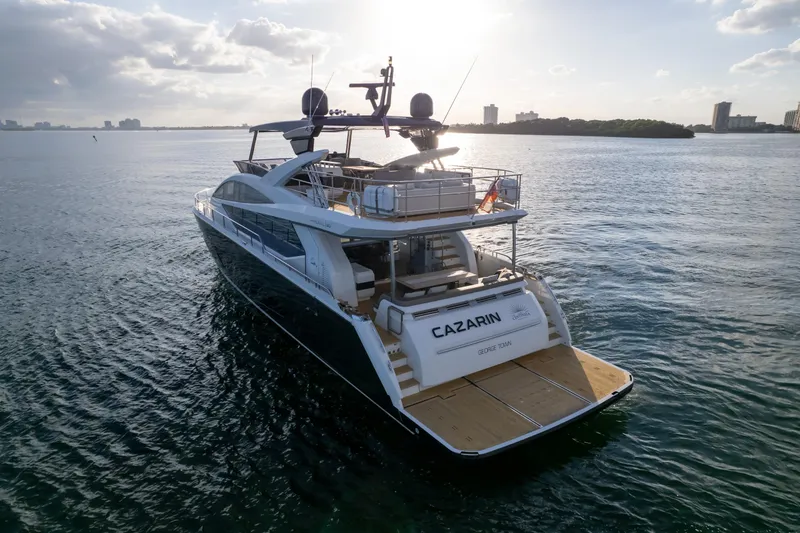 Slide: The Image of Luxurious 2020 Pearl 80 yacht cruising on serene waters at sunset. - 21
