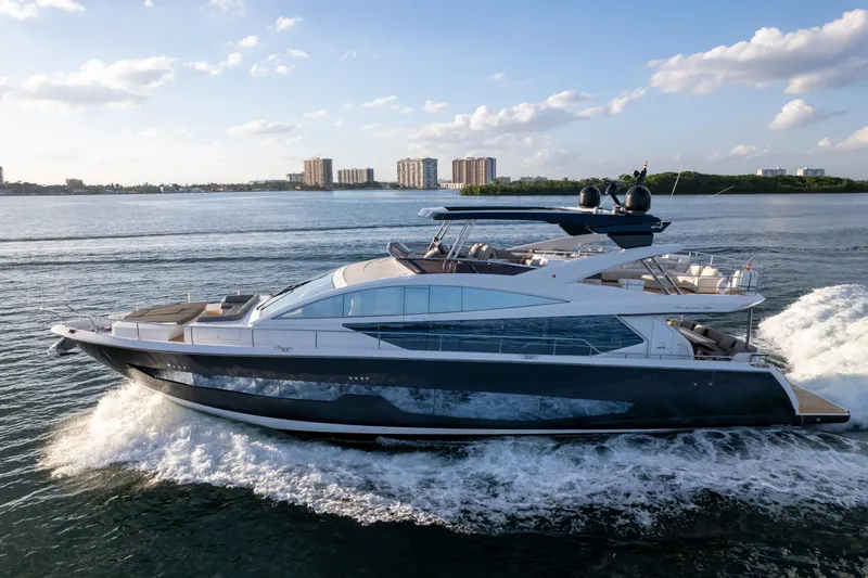 Slide: The Image of Luxurious 2020 Pearl 80 yacht cruising on open water under a clear blue sky. - 22