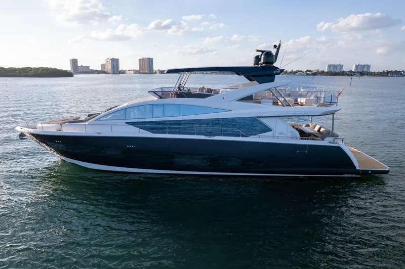Slide: The Image of Luxurious 2020 Pearl 80 yacht cruising on calm waters under a clear sky. - 23