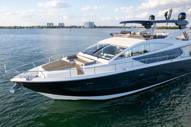 Slide: The Image of Luxurious 2020 Pearl 80 yacht cruising on serene waters under a partly cloudy sky. - 24