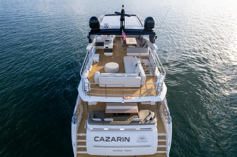 Slide: The Image of Luxurious 2020 Pearl 80 yacht on water, featuring spacious deck and elegant seating. - 25