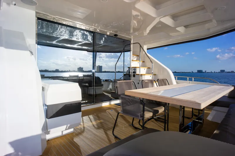 Slide: The Image of Luxurious Pearl 80 yacht interior with dining area, overlooking serene ocean view, 2020 model. - 32