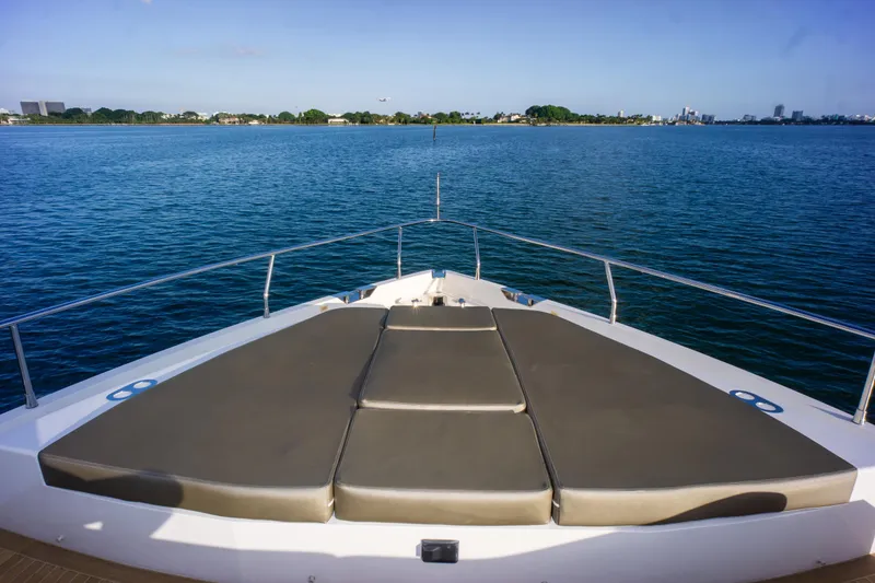 Slide: The Image of Bow view of 2020 Pearl 80 yacht with sunbathing area, overlooking calm blue waters. - 40