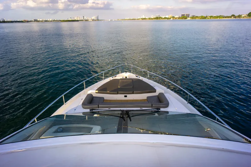Slide: The Image of Bow view of 2020 Pearl 80 yacht cruising on calm waters under a cloudy sky. - 42