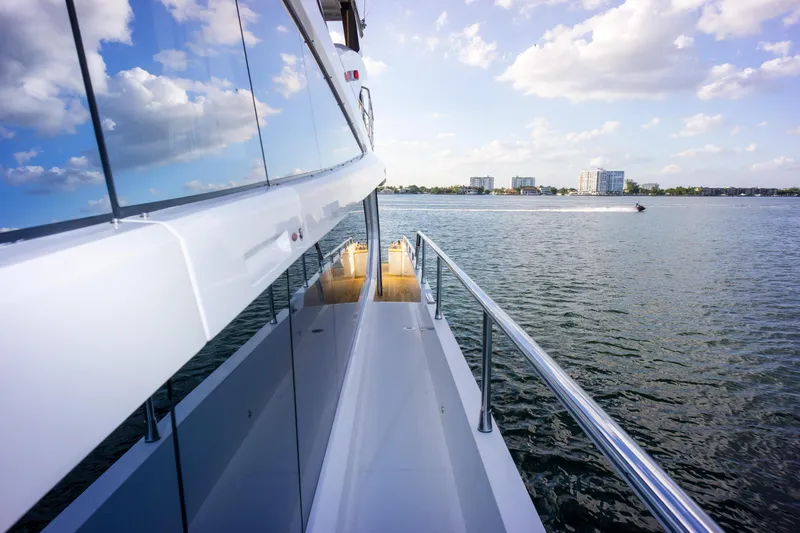 Slide: The Image of Luxury Pearl 80 yacht on water, reflecting sky and clouds, 2020 model. - 43