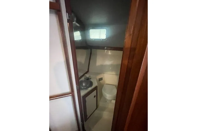 Slide: The Image of Compact bathroom in 1988 Albin 34 Cruiser with sink, toilet, and window. - 10