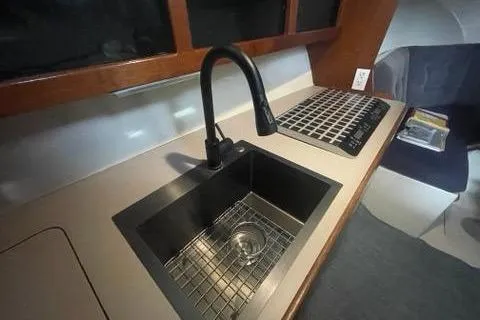 Slide: The Image of 1988 Albin 34 Cruiser kitchen sink with modern faucet and stove. - 13