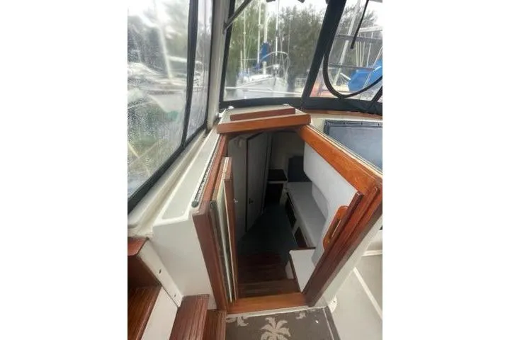 Slide: The Image of 1988 Albin 34 Cruiser interior with wooden stairs and seating area. - 15