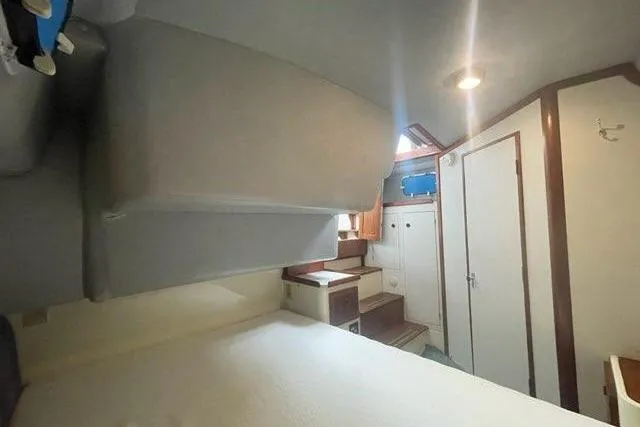 Slide: The Image of Interior of 1988 Albin 34 Cruiser, featuring cozy cabin with bed and storage. - 20