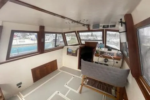 Slide: The Image of Interior of 1988 Albin 34 Cruiser boat with helm and seating area. - 25