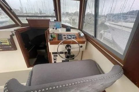 Slide: The Image of 1988 Albin 34 Cruiser helm with steering wheel and navigation controls. - 26