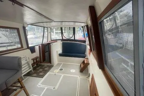 Slide: The Image of 1988 Albin 34 Cruiser interior with seating, windows, and nautical decor. - 28
