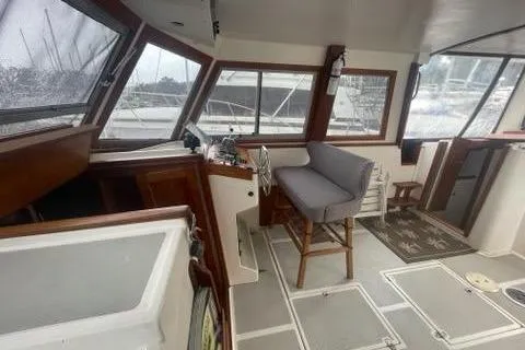 Slide: The Image of 1988 Albin 34 Cruiser interior with helm, seating, and large windows. - 29