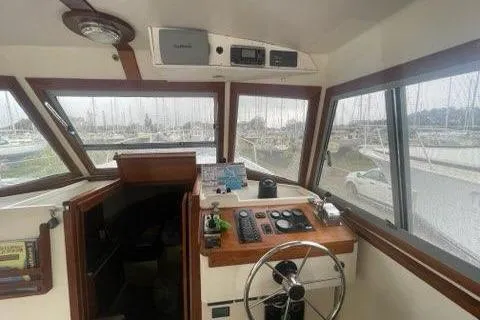 Slide: The Image of 1988 Albin 34 Cruiser helm with navigation equipment and marina view. - 30