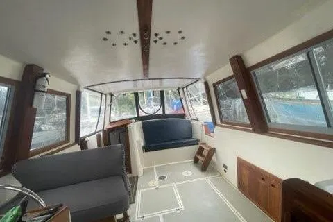 Slide: The Image of 1988 Albin 34 Cruiser interior with seating, windows, and wooden accents. - 31