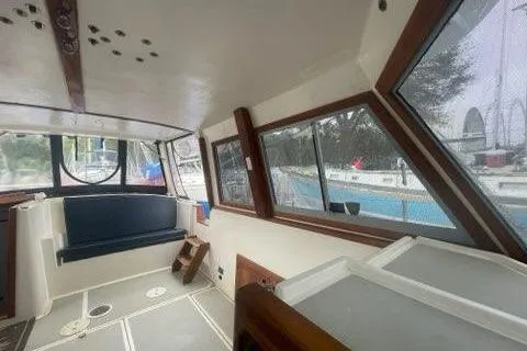 Slide: The Image of Interior view of 1988 Albin 34 Cruiser with spacious seating and large windows. - 33
