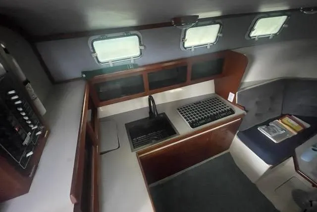 Slide: The Image of Interior of 1988 Albin 34 Cruiser with kitchen and seating area. - 34