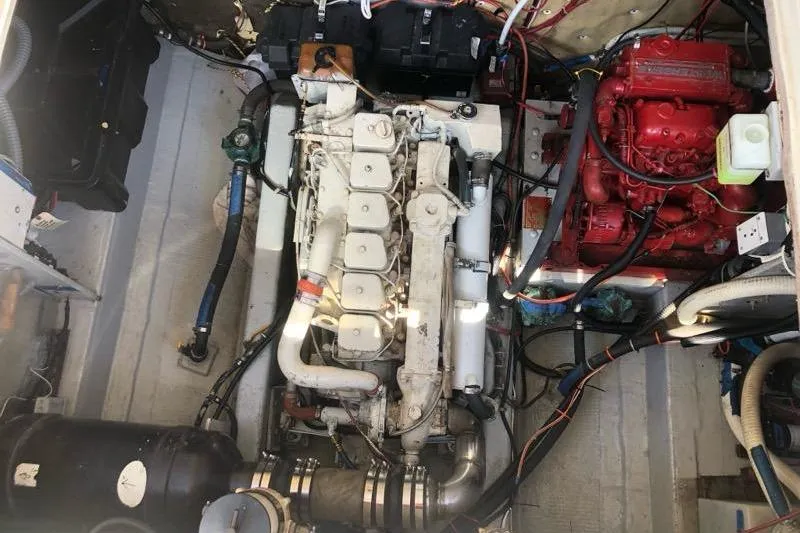 Slide: The Image of Engine compartment of a 1988 Albin 34 Cruiser, showcasing mechanical components and wiring. - 38