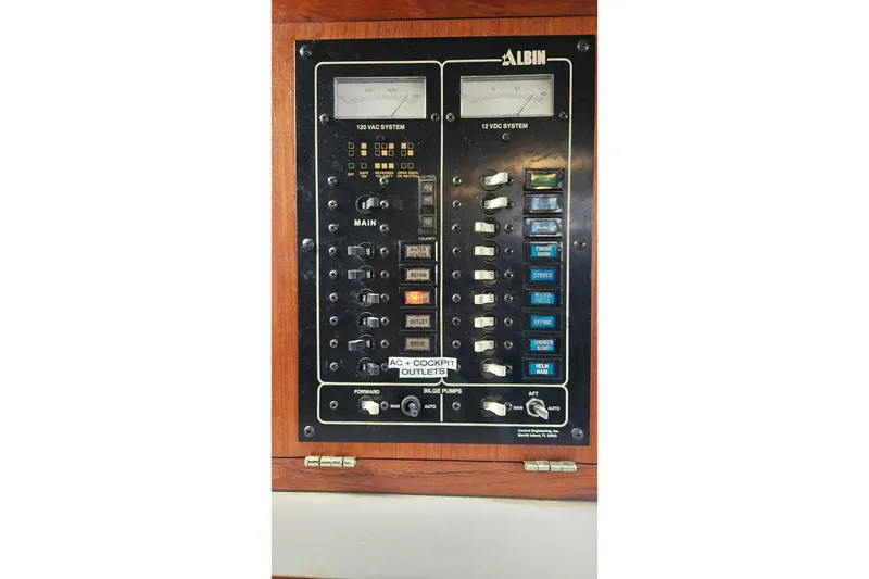 Slide: The Image of Electrical control panel of a 1988 Albin 34 Cruiser boat, featuring AC and DC systems. - 41