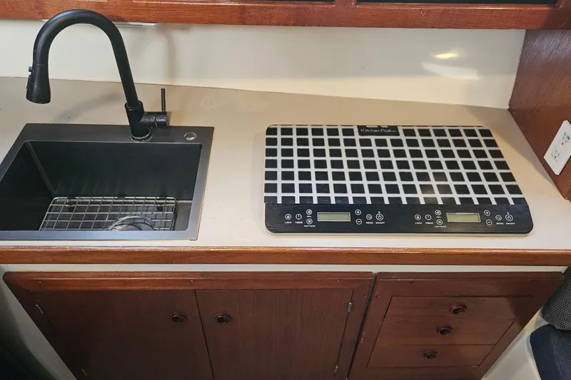 Slide: The Image of 1988 Albin 34 Cruiser kitchen with sink and induction cooktop. - 44