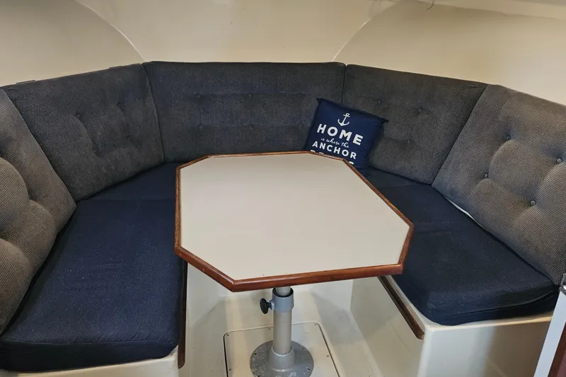 Slide: The Image of Interior of 1988 Albin 34 Cruiser with cozy seating and nautical-themed pillow. - 45