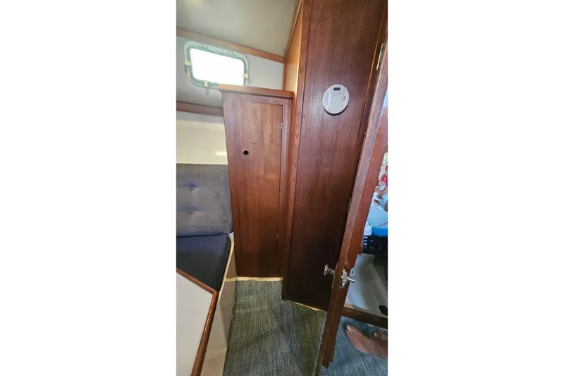 Slide: The Image of Interior of 1988 Albin 34 Cruiser with wooden cabinetry and seating area. - 49