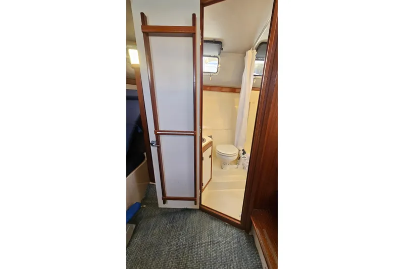 Slide: The Image of 1988 Albin 34 Cruiser bathroom interior with shower and toilet. - 54