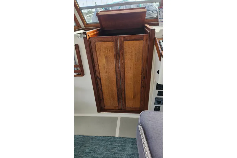 Slide: The Image of Wooden cabinet inside 1988 Albin 34 Cruiser boat, featuring a classic design. - 57