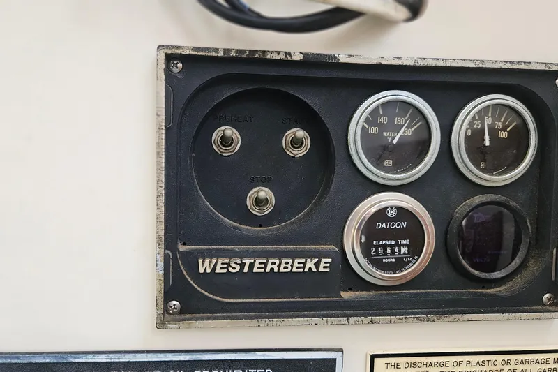 Slide: The Image of Control panel of a 1988 Albin 34 Cruiser with Westerbeke engine gauges. - 64