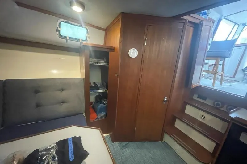 Slide: The Image of Interior of 1988 Albin 34 Cruiser with wooden cabinetry and seating area. - 7
