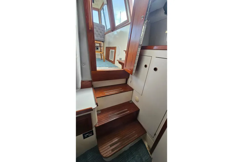Slide: The Image of Interior stairs of 1988 Albin 34 Cruiser with wooden steps and cabin view. - 72