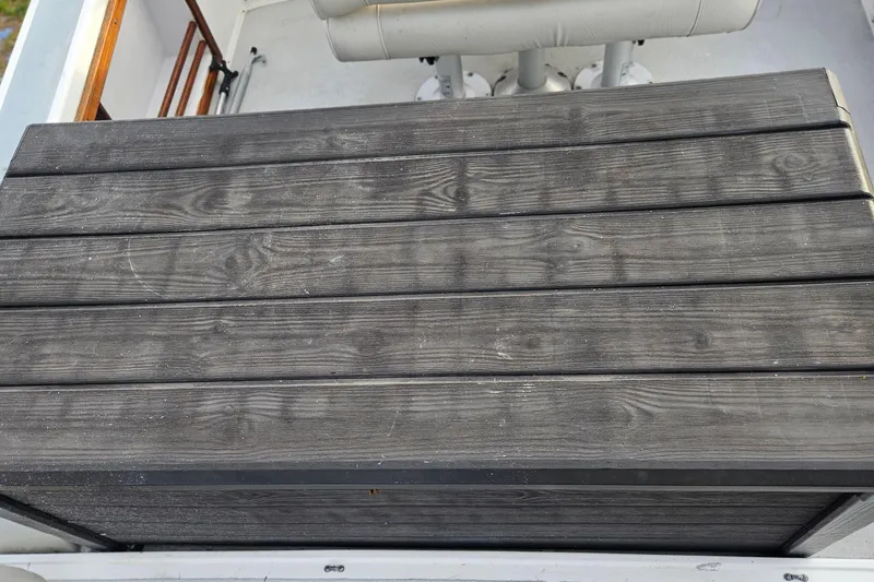 Slide: The Image of 1988 Albin 34 Cruiser with wooden deck and white seating area. - 82