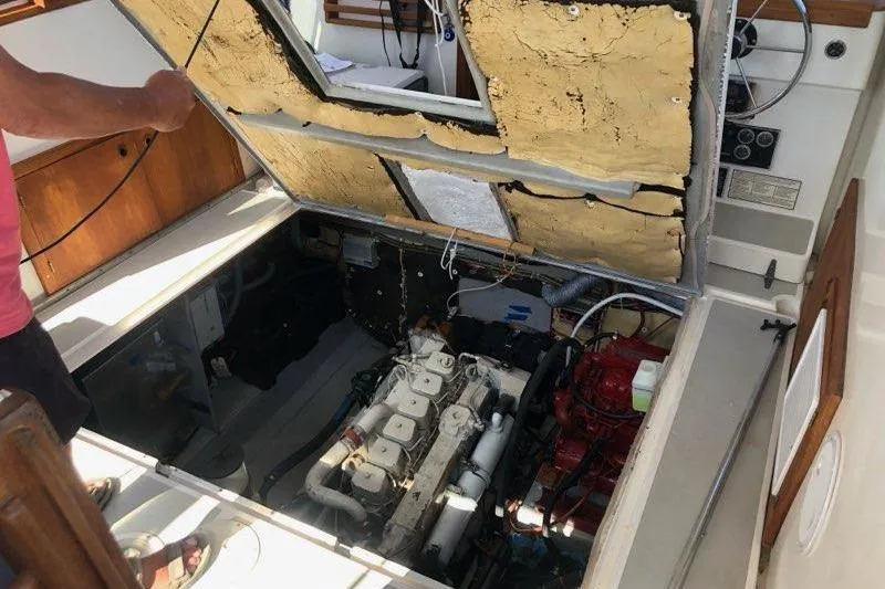 Slide: The Image of 1988 Albin 34 Cruiser engine compartment with open hatch, revealing engine details. - 87