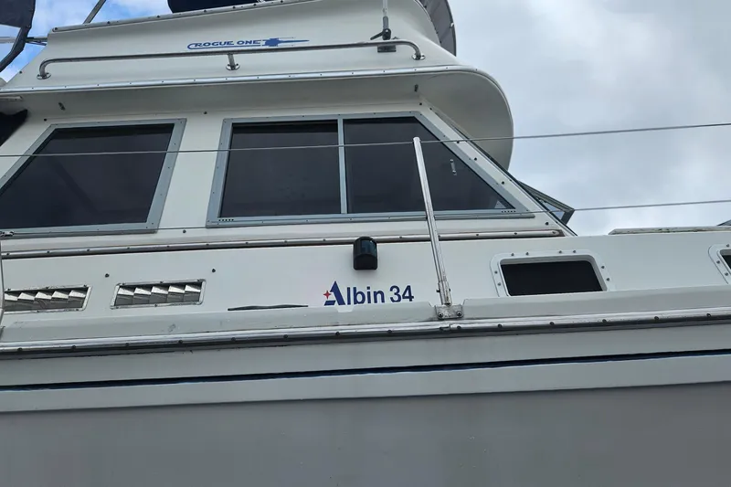Slide: The Image of 1988 Albin 34 Cruiser boat with windows and "Rogue One" label on top. - 88