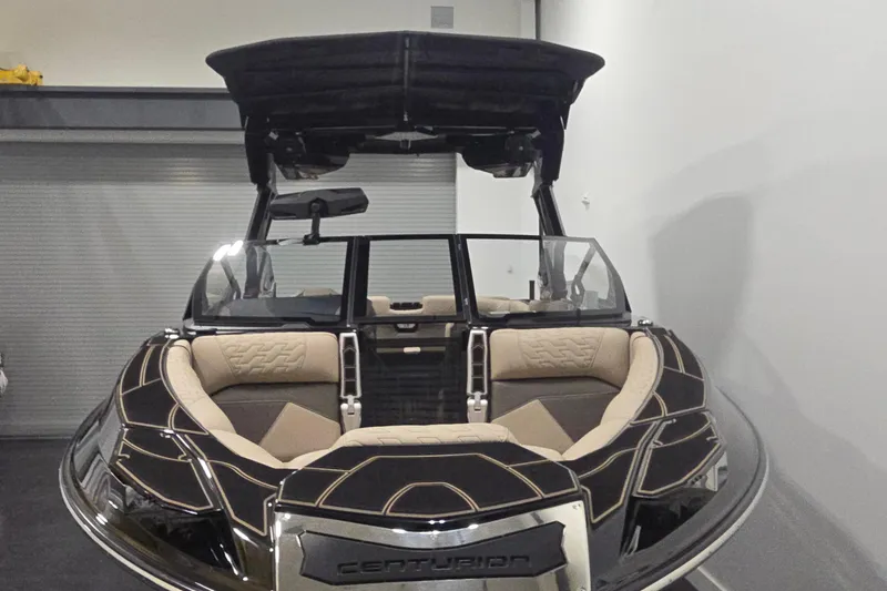 Slide: The Image of 2026 Centurion R1245 boat with sleek design and luxurious seating in a showroom. - 4
